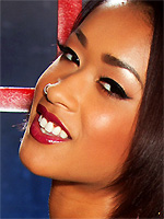 Skin Diamond peels off latex lingerie in a cage